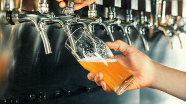 Bartender-pours-a-Draft-beer-or-Draught-Beer-at-the-bar